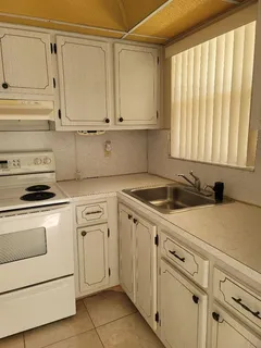 a view of a kitchen with white cabinets