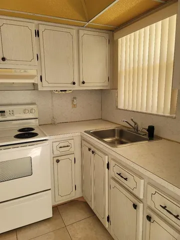 a view of a kitchen with white cabinets