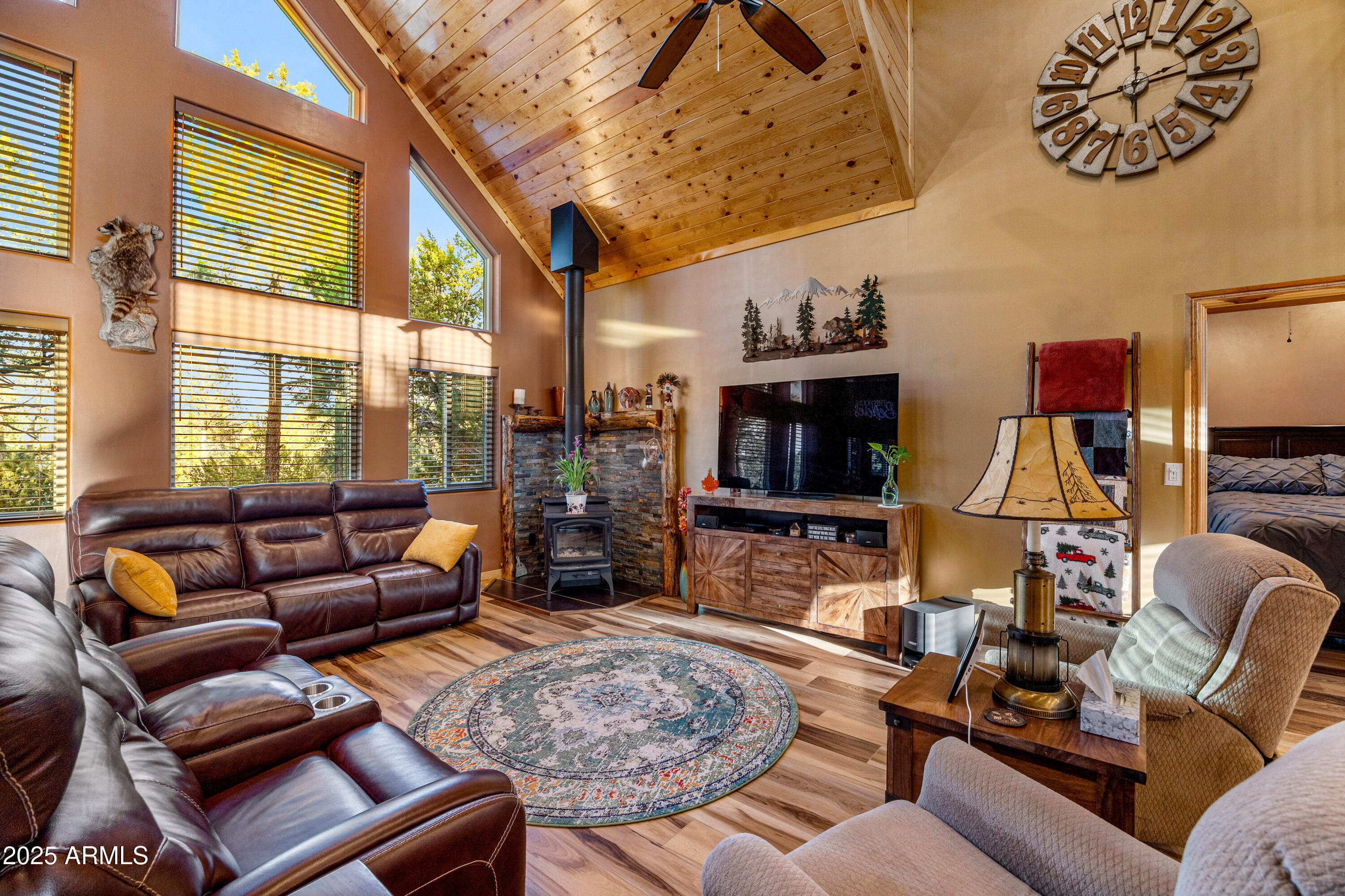3334 Sawmill Ridge Loop Heber, AZ 85928 - Photo 9 of 58 a living room with furniture a flat screen tv and a large window
