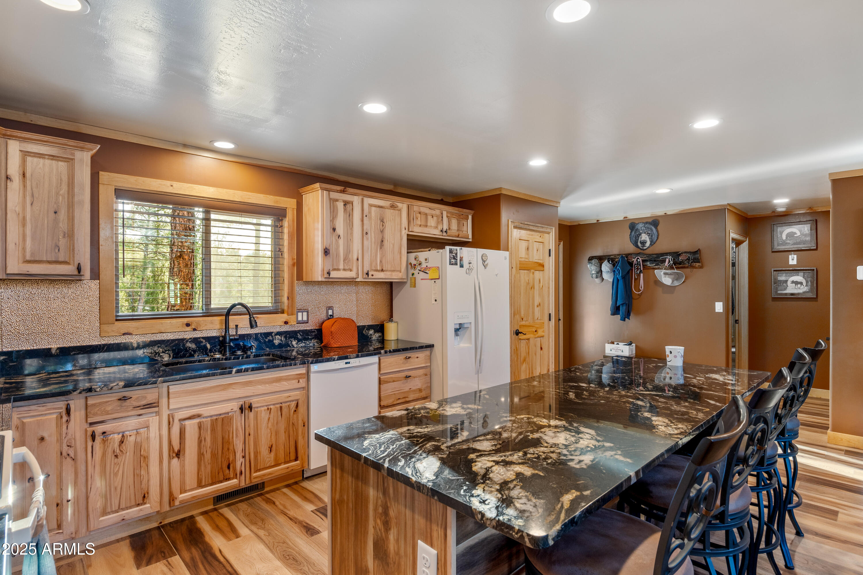 3334 Sawmill Ridge Loop Heber, AZ 85928 - Photo 13 of 58 a kitchen with stainless steel appliances granite countertop a sink stove and refrigerator