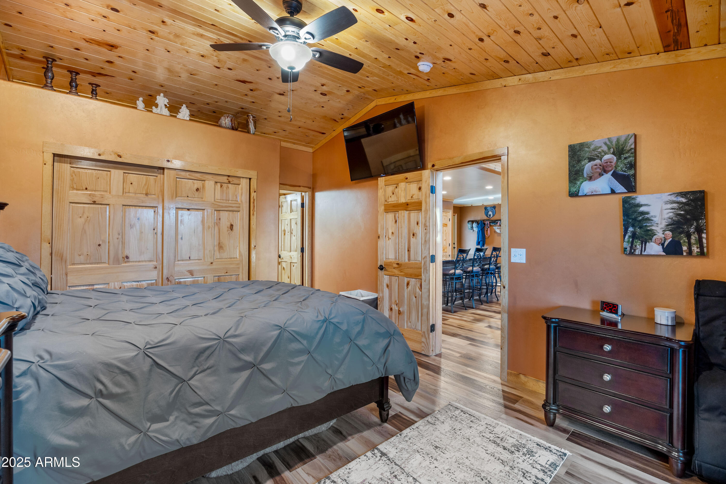 3334 Sawmill Ridge Loop Heber, AZ 85928 - Photo 17 of 58 a spacious bedroom with a bed and a chandelier
