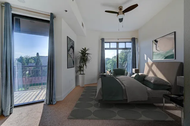 a spacious bedroom with a large bed and windows