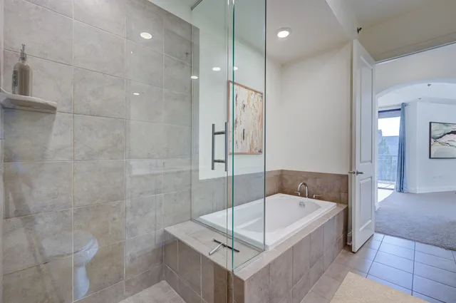 a bathroom with a tub and shower