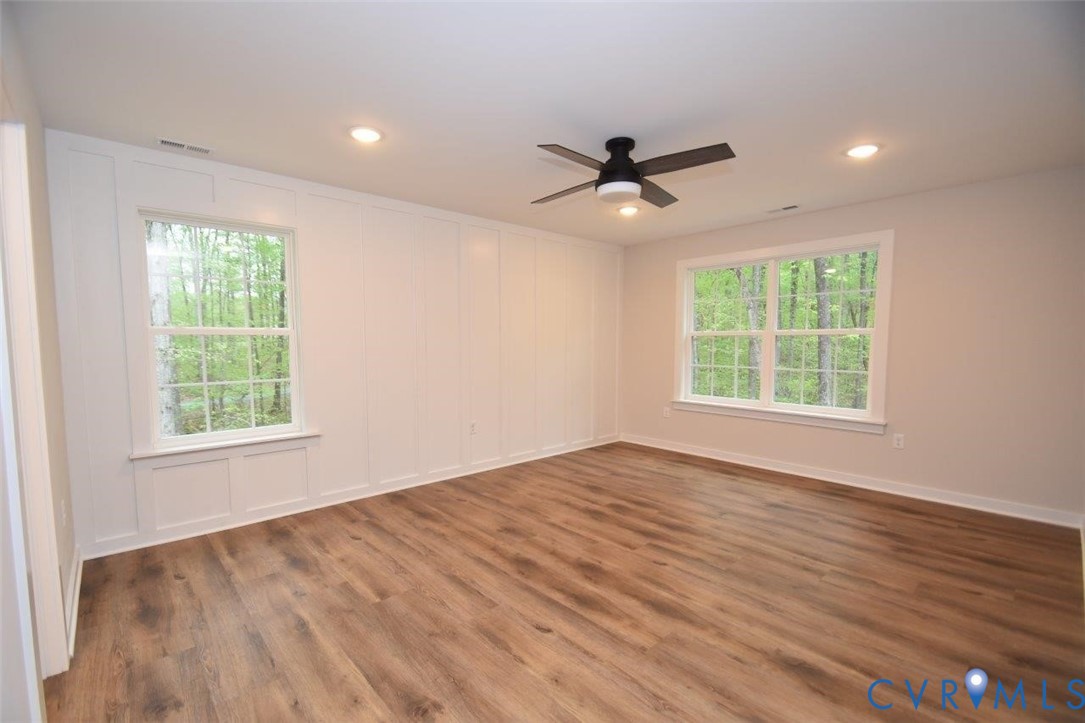 1749 Hollands Road Palmyra, VA 22963 - Photo 22 of 40 Empty room with a decorative wall, wood finished f