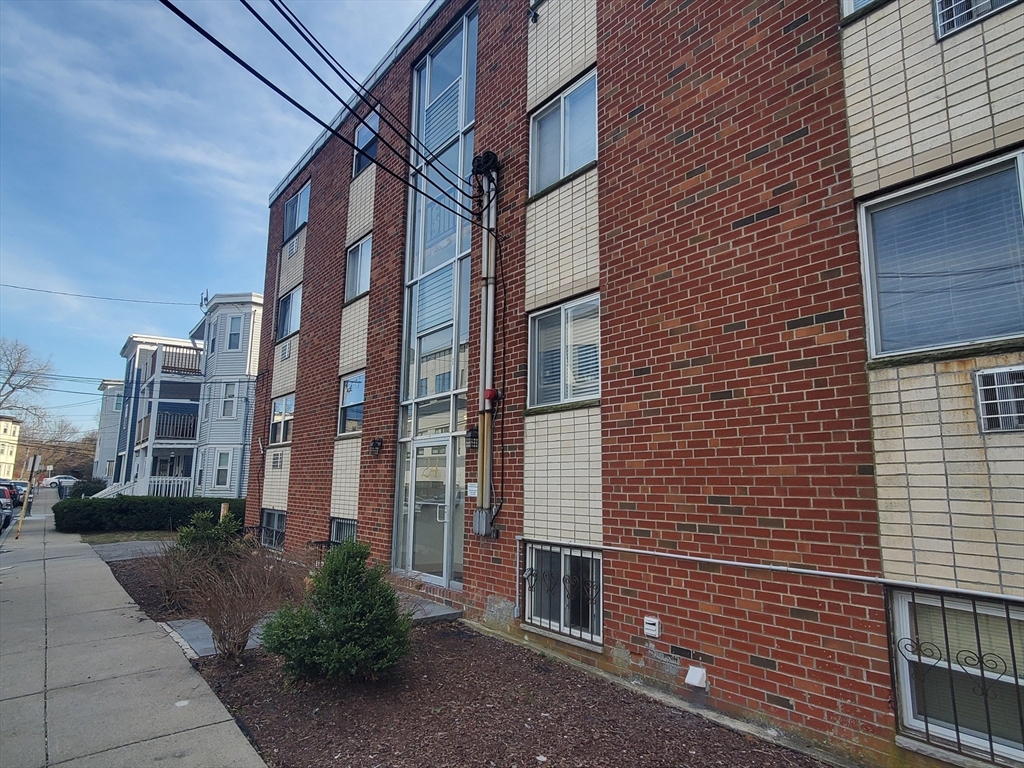 24 Colgate Road, Unit 5 Boston, MA 02131 - Photo 12 of 13 a view of a brick building with many windows