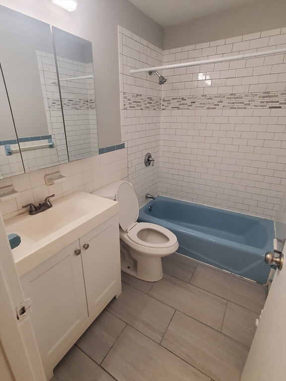 24 Colgate Road, Unit 5 Boston, MA 02131 - Photo 8 of 13 a bathroom with a sink a toilet and shower