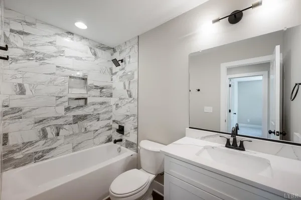 a bathroom with a sink a toilet and a bathtub