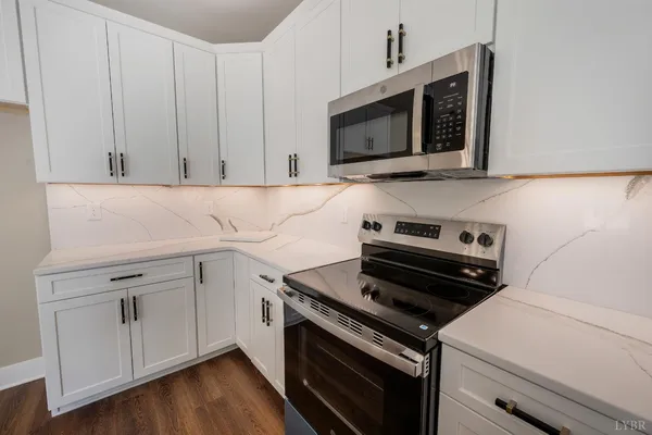 a kitchen with a stove and a microwave
