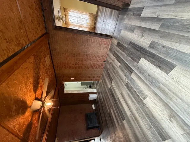 a view of a room with wooden floor and windows