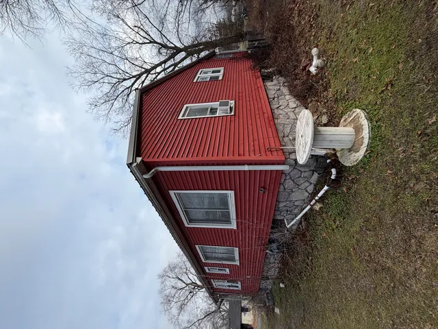 a view of a house with a tree