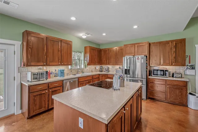 a bed sitting in a spacious bedroom next to a window