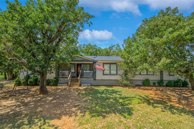 a view of a house with wooden deck