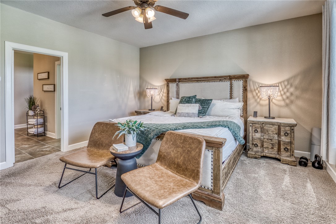 586 Ruby Drive Bellville, TX 77418 - Photo 18 of 50 a bedroom with a bed a chair and with the dresser