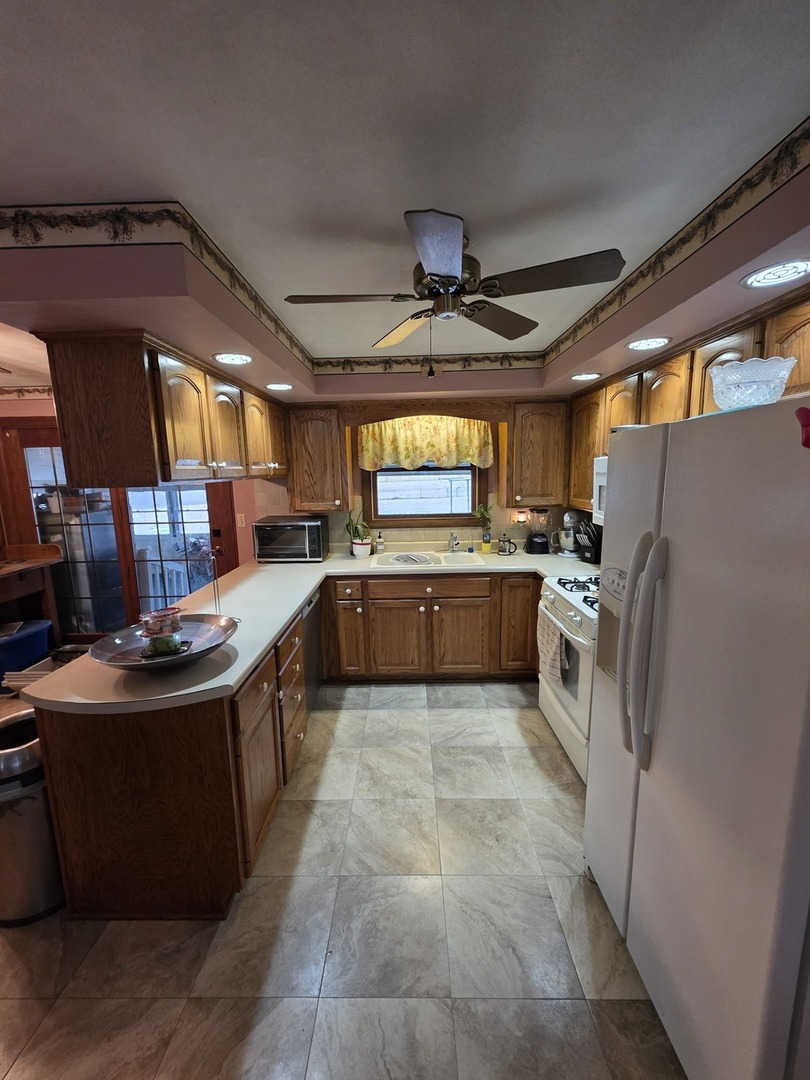 503 North Walnut Street Delavan, IL 61734 - Photo 18 of 32 a large kitchen with stainless steel appliances granite countertop a stove top oven a sink and a refrigerator