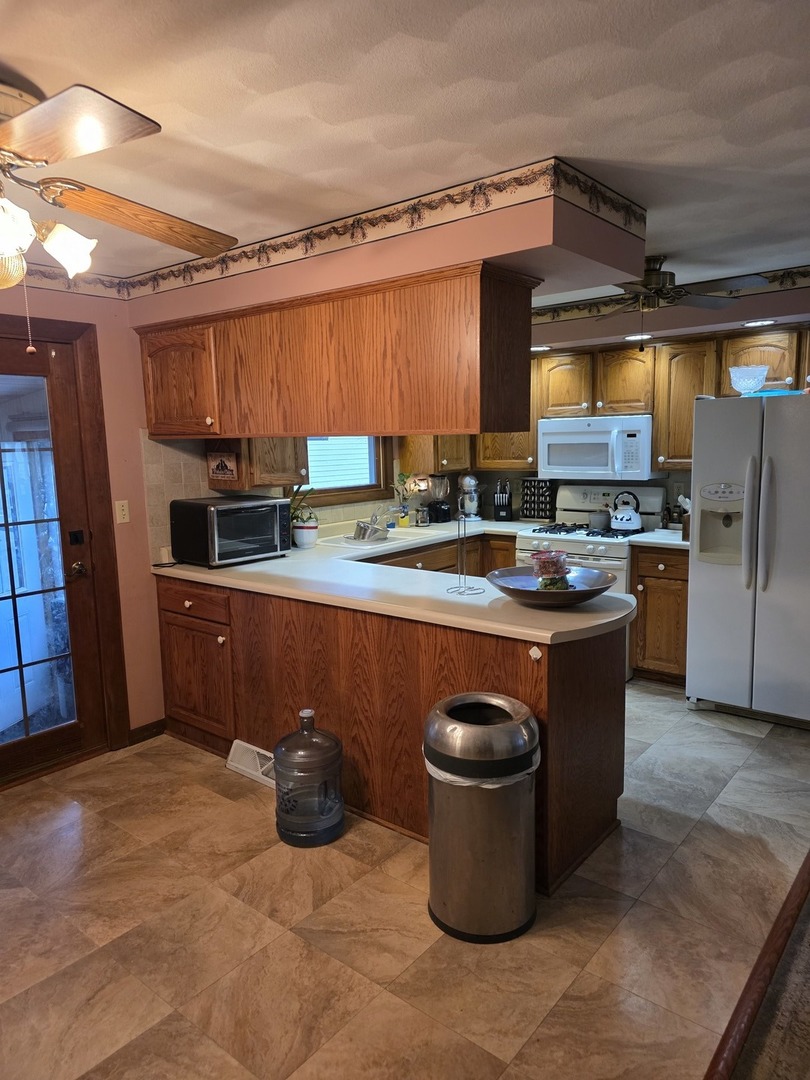 503 North Walnut Street Delavan, IL 61734 - Photo 19 of 32 a kitchen with stainless steel appliances granite countertop a stove a sink and a refrigerator