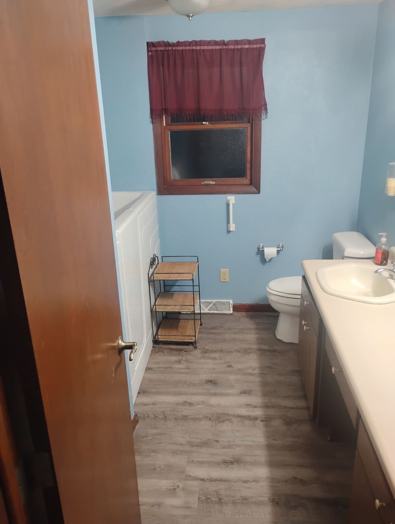 503 North Walnut Street Delavan, IL 61734 - Photo 25 of 32 a bathroom with a toilet a sink and a mirror