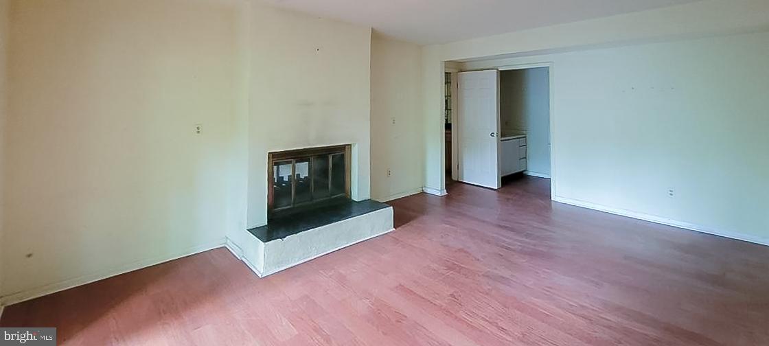 533 Pugh Road Wayne, PA 19087 - Photo 14 of 27 an empty room with wooden floor and fireplace
