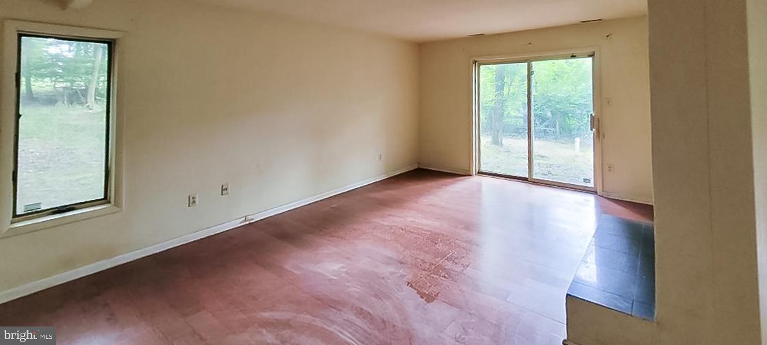 533 Pugh Road Wayne, PA 19087 - Photo 15 of 27 an empty room with wooden floor and windows