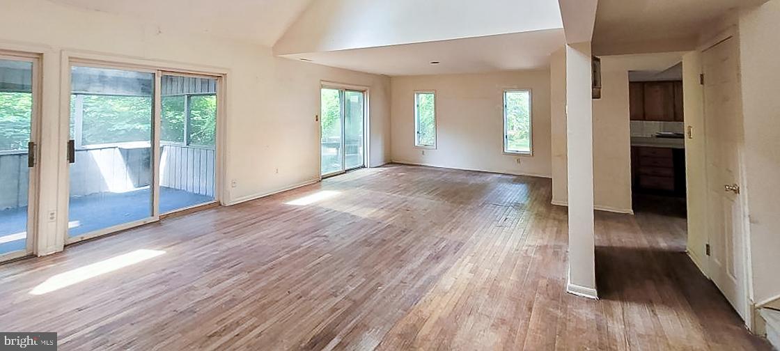 533 Pugh Road Wayne, PA 19087 - Photo 6 of 27 an empty room with wooden floor and windows