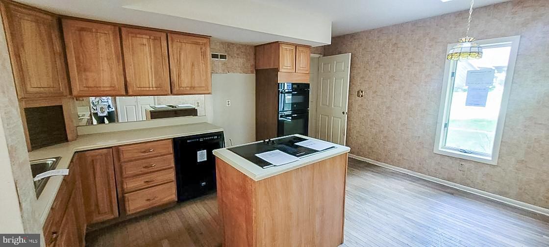 533 Pugh Road Wayne, PA 19087 - Photo 8 of 27 a kitchen with stainless steel appliances granite countertop a sink stove and refrigerator