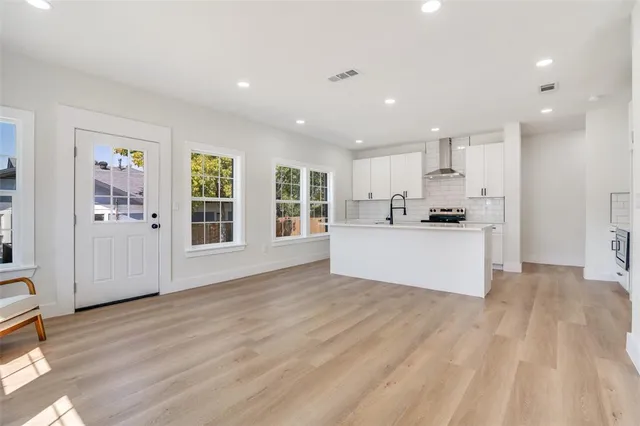 a view of kitchen with wooden floor and electronic appliances