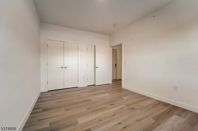 a view of an empty room and wooden floor