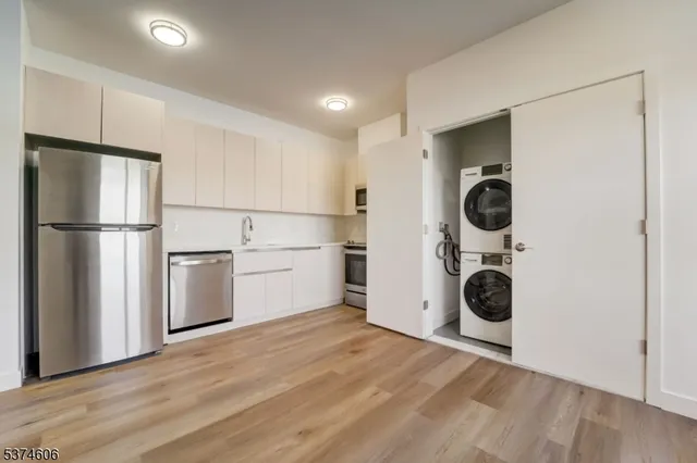 a view of a kitchen with a washer and dryer