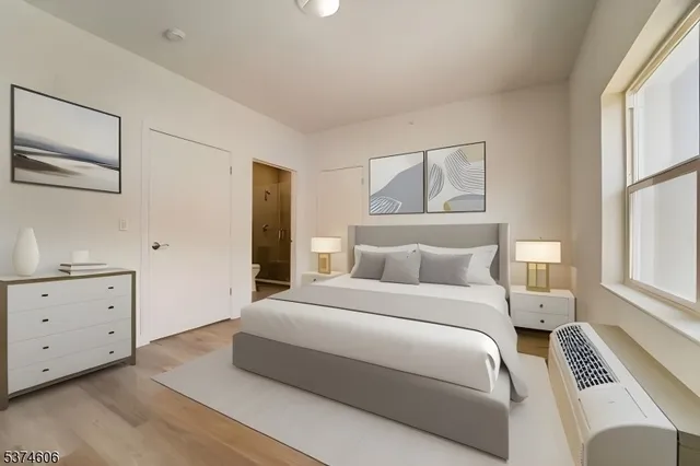 a bedroom with a bed and a window