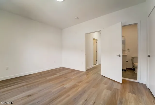 a view of an empty room and wooden floor