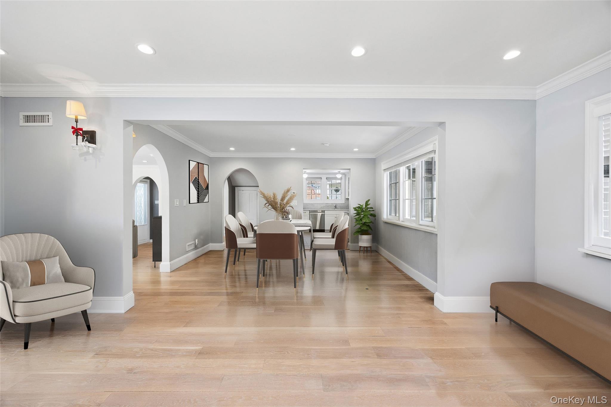 216 Beverly Road Queens, NY 11363 - Photo 7 of 50 a view of a livingroom with furniture and a dining table with wooden floor