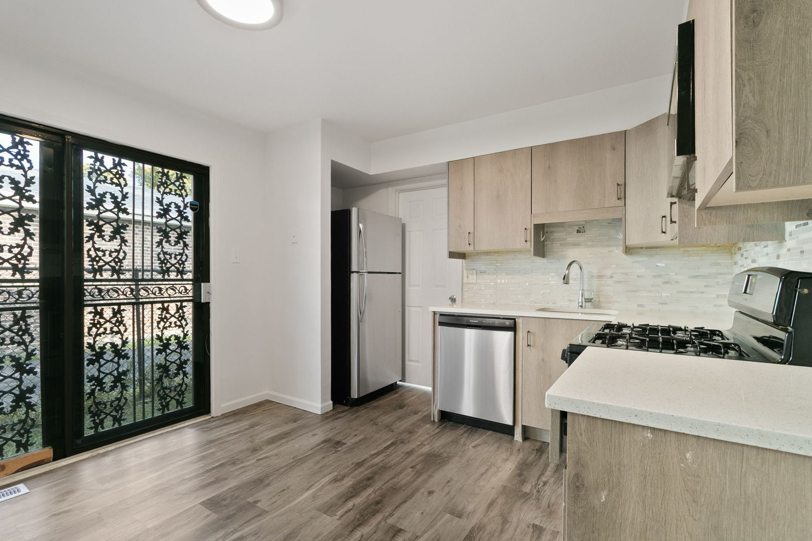2236 West 157th Place Markham, IL 60426 - Photo 5 of 14 a kitchen with a stove a sink and a refrigerator
