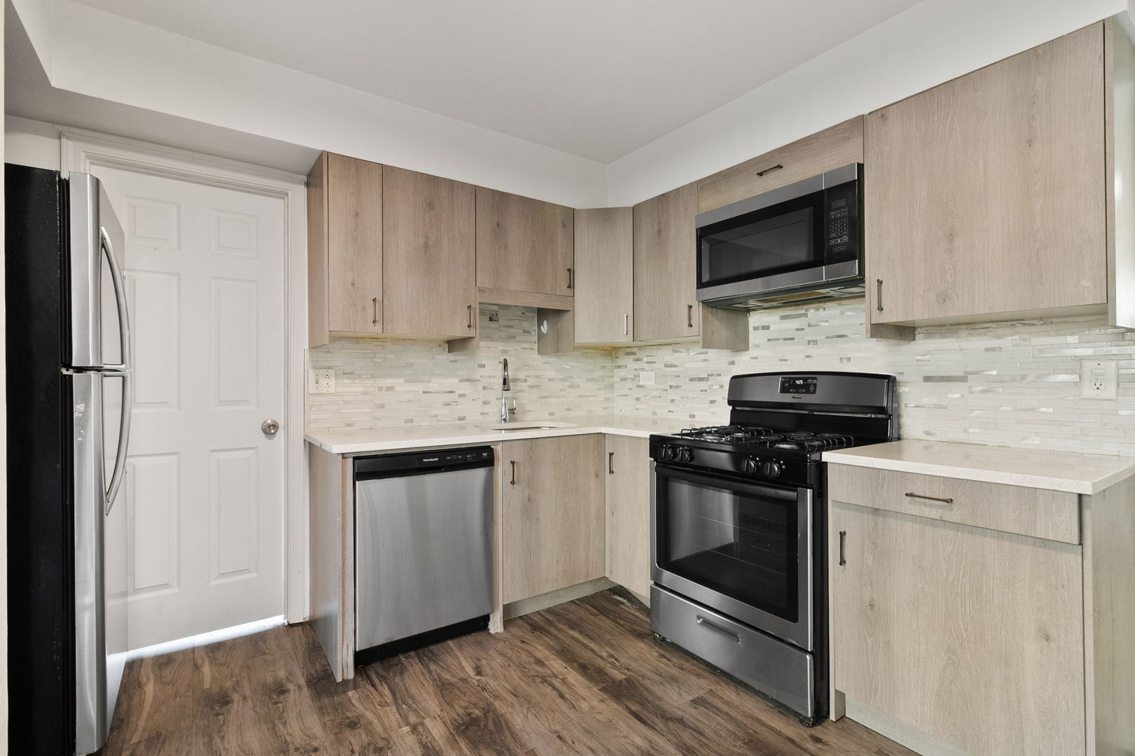 2236 West 157th Place Markham, IL 60426 - Photo 6 of 14 a kitchen with stainless steel appliances granite countertop a stove microwave sink and refrigerator