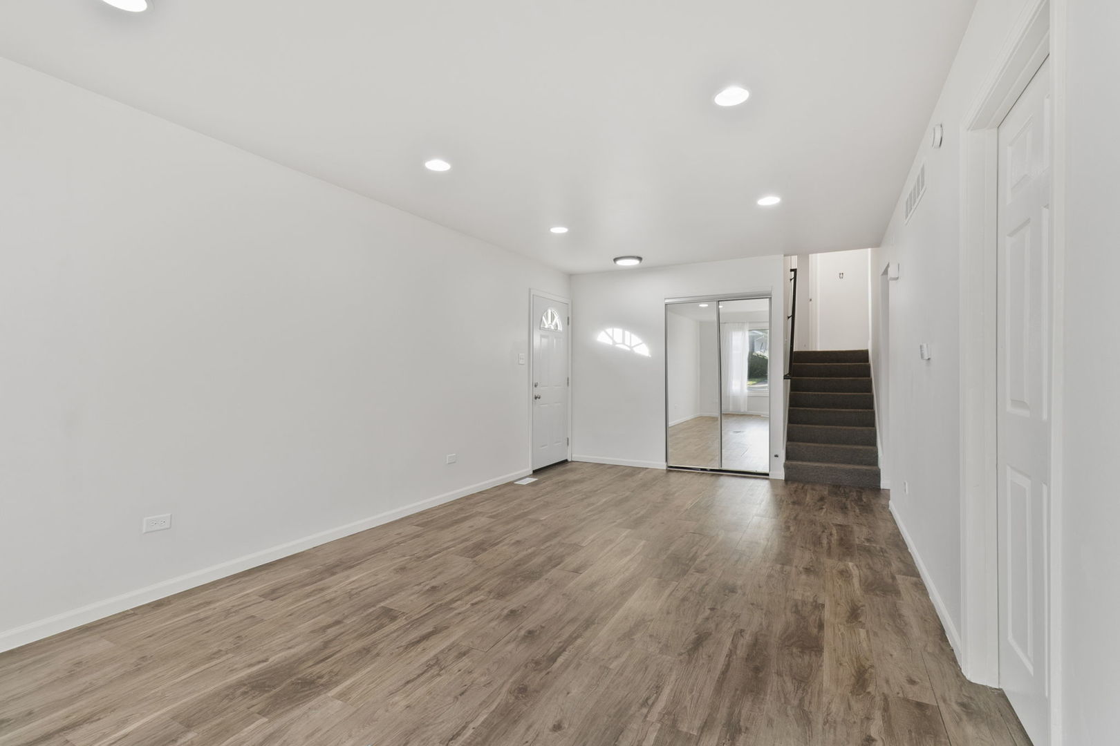 2236 West 157th Place Markham, IL 60426 - Photo 7 of 14 a view of an empty room with wooden floor and a window