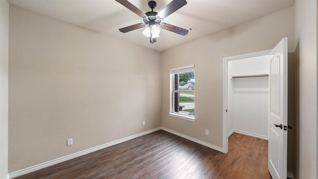 1401 Ridgebriar Drive Kaufman, TX 75142 - Photo 17 of 26 Bedroom featuring walk in closet