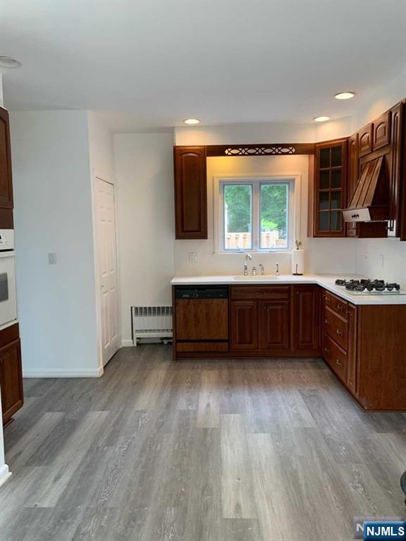 73 East Gouverneur Avenue Rutherford, NJ 07070 - Photo 7 of 33 a kitchen with stainless steel appliances granite countertop a stove a sink and a large window