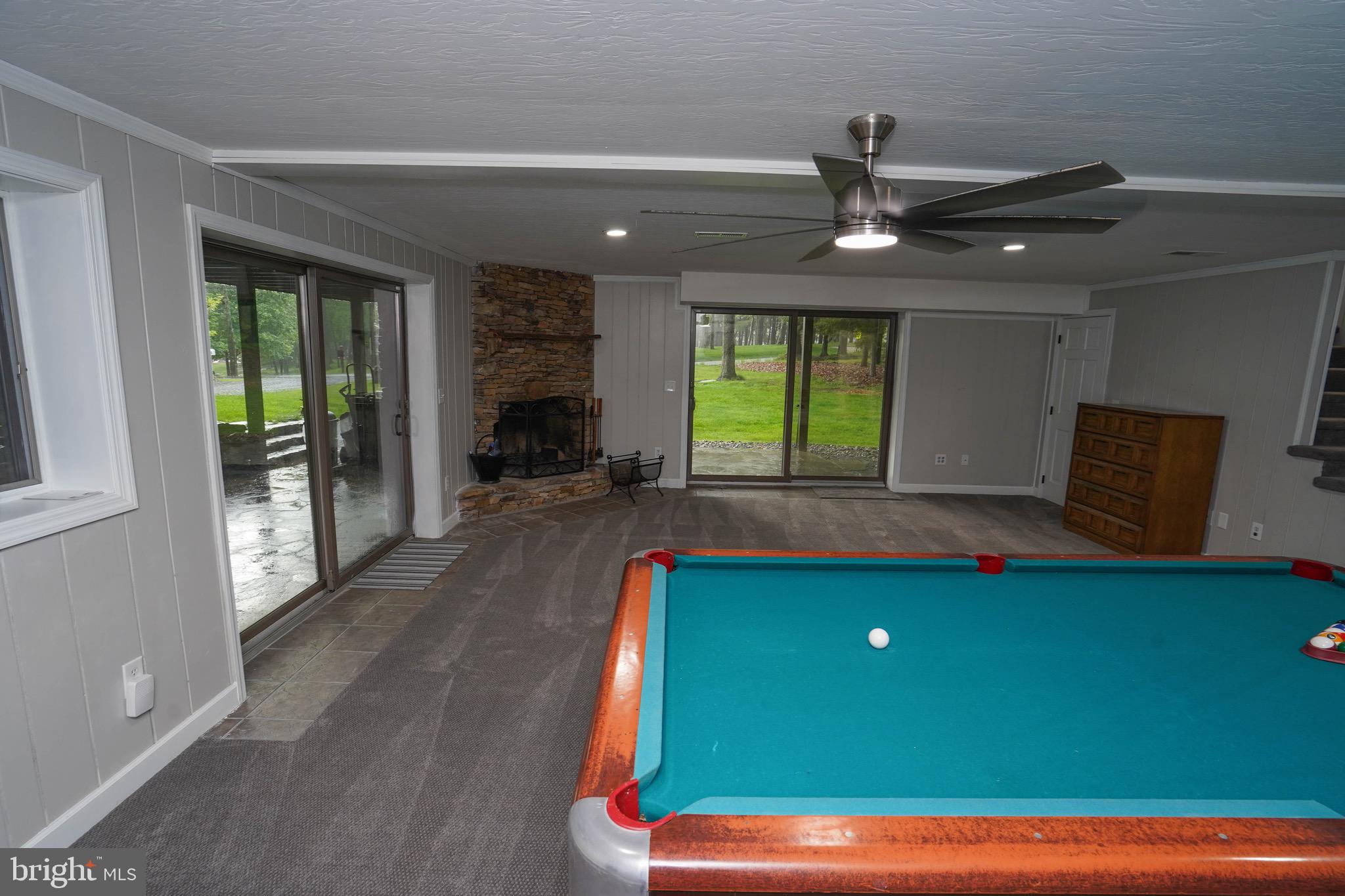 639 Beckmans Peninsula Road Swanton, MD 21561 - Photo 50 of 69 Lower lvl pool table, living room, wood fireplace