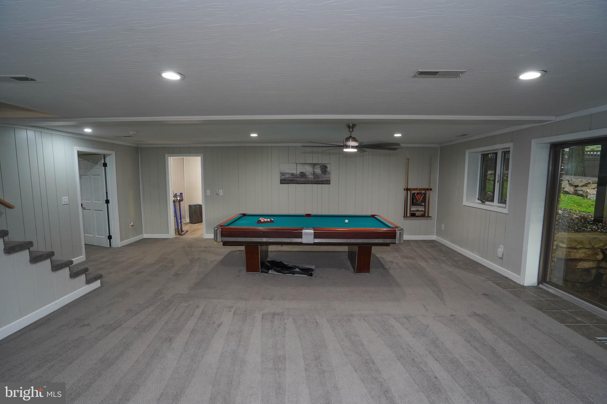 639 Beckmans Peninsula Road Swanton, MD 21561 - Photo 54 of 69 Lower lvl pool table, living room, wood fireplace