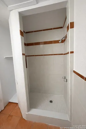 a bathroom with a glass shower door