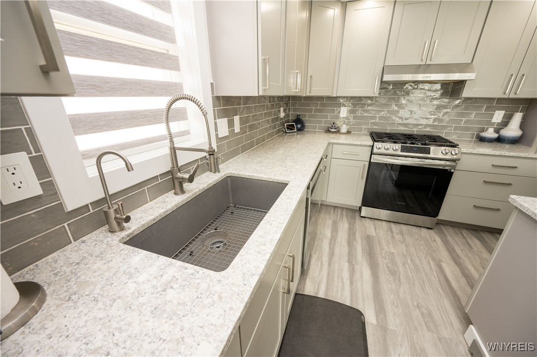 1225 Losson Road Cheektowaga, NY 14227 - Photo 13 of 47 Living room with large windows to the private back