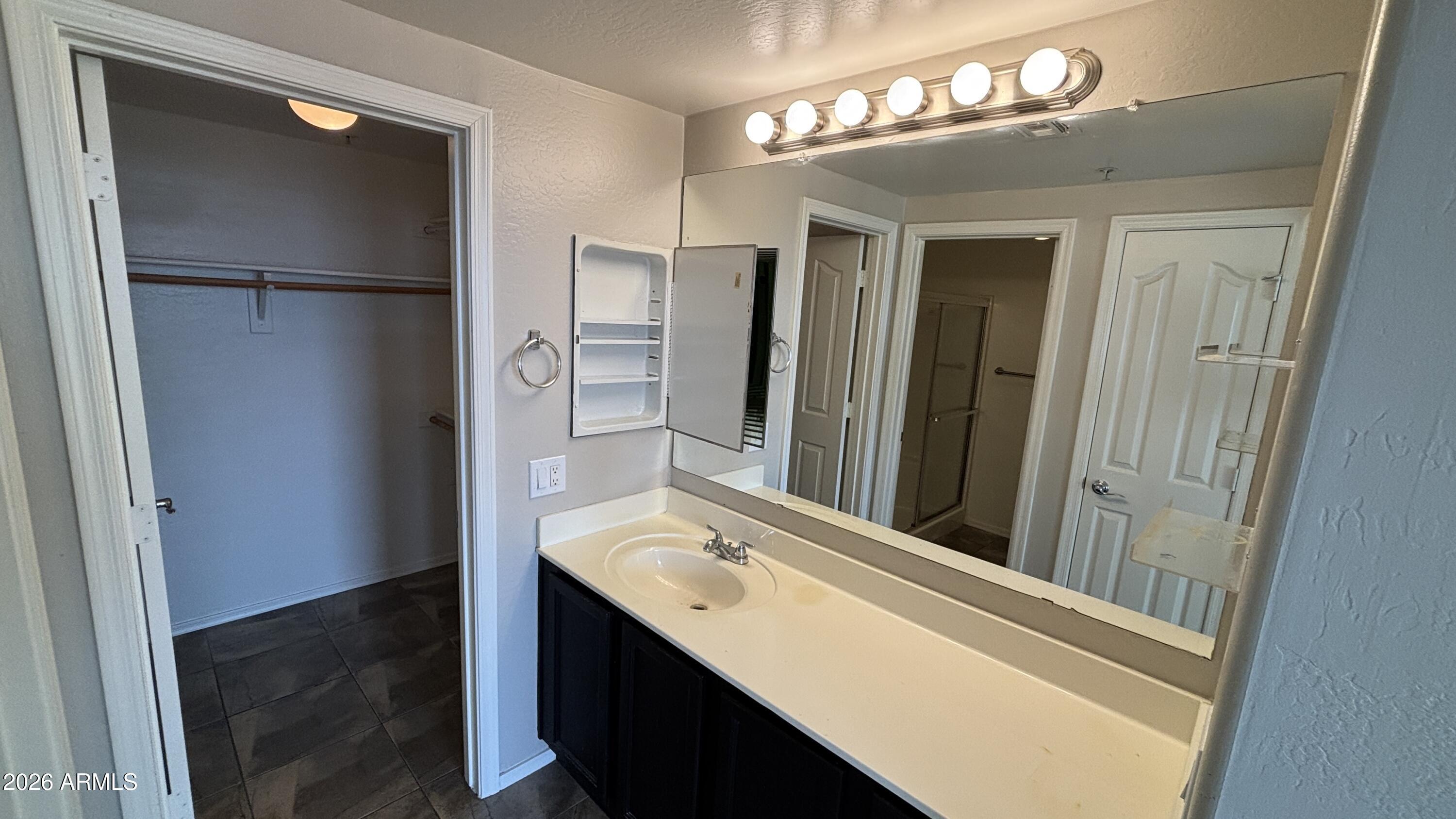 3250 West Greenway Road, Unit 104 Phoenix, AZ 85053 - Photo 14 of 26 a bathroom with a sink and a mirror