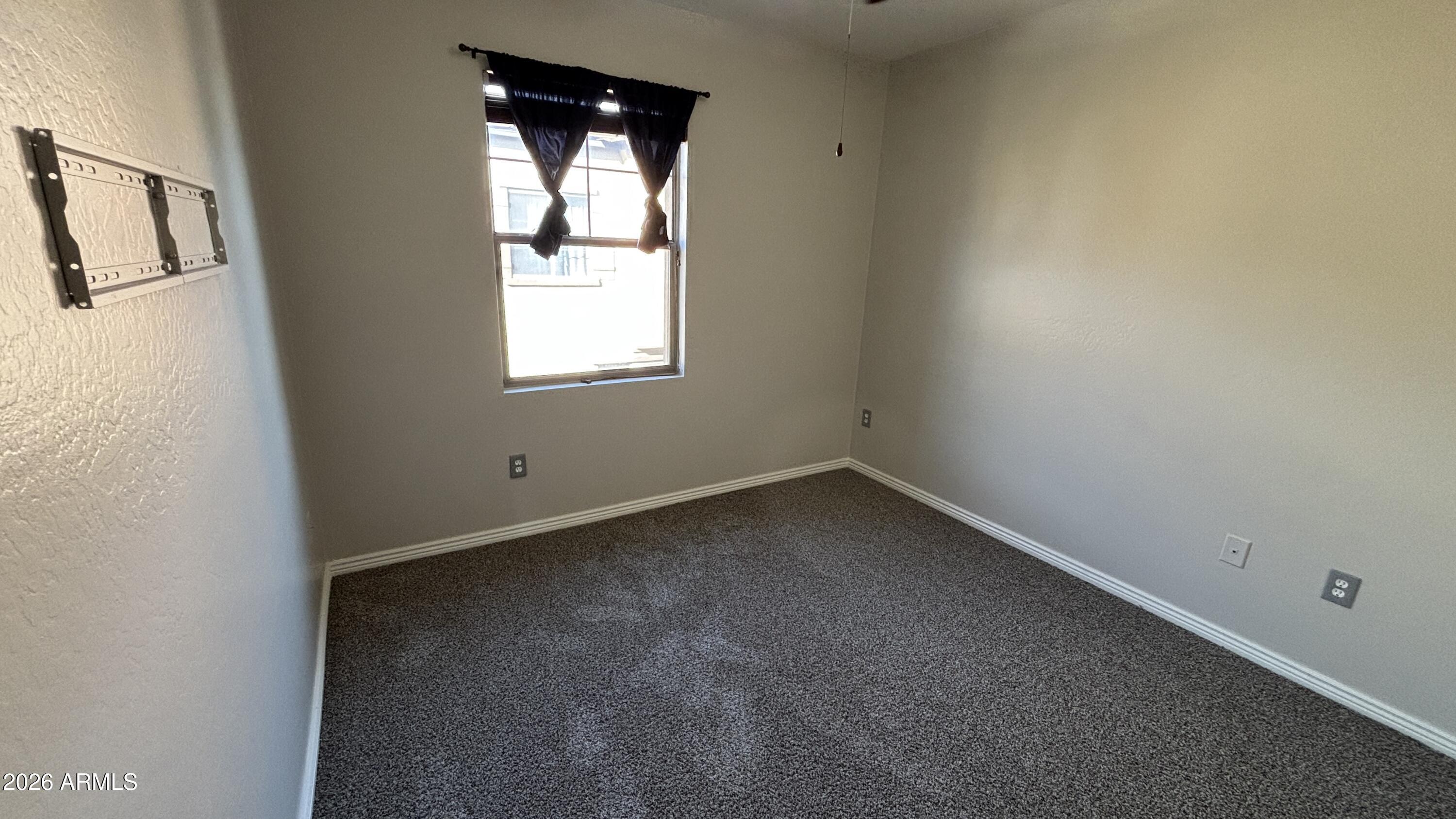 3250 West Greenway Road, Unit 104 Phoenix, AZ 85053 - Photo 18 of 26 an empty room with a window