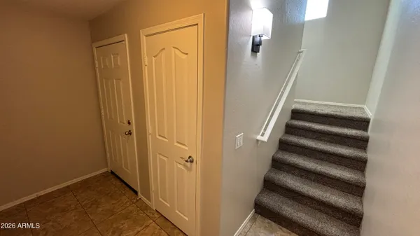 a view of empty room with wooden floor and window