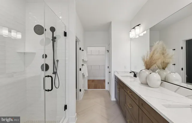a bedroom with a bed chandelier and a dresser