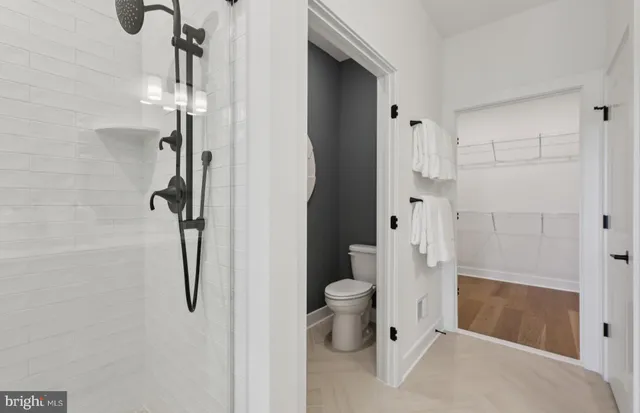 a bathroom with a double vanity sink mirror and shower