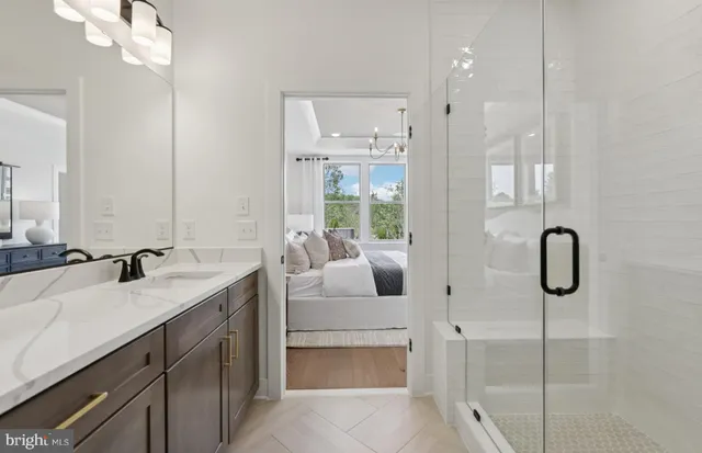 a bathroom with a double vanity sink a mirror and a shower