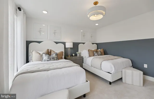 a bedroom with two beds and painting on the wall