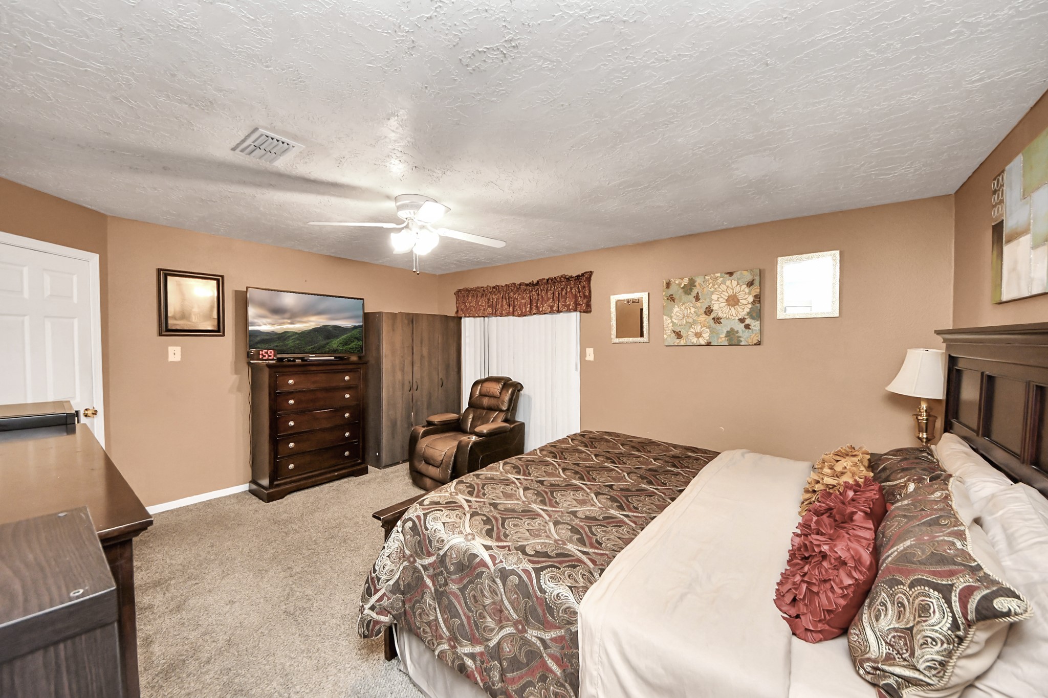 4155 Amir Street Houston, TX 77072 - Photo 36 of 43 a bedroom with a large bed and a tv