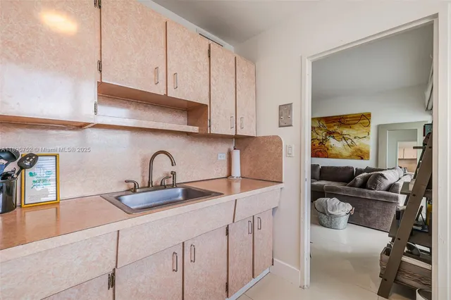 a bedroom with a bed and painting on the wall