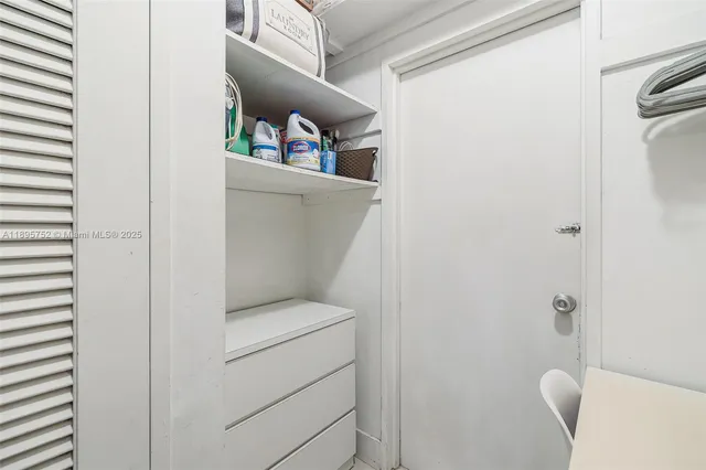 a living room with patio furniture and a large window