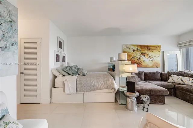 a bedroom with a bed and a couch